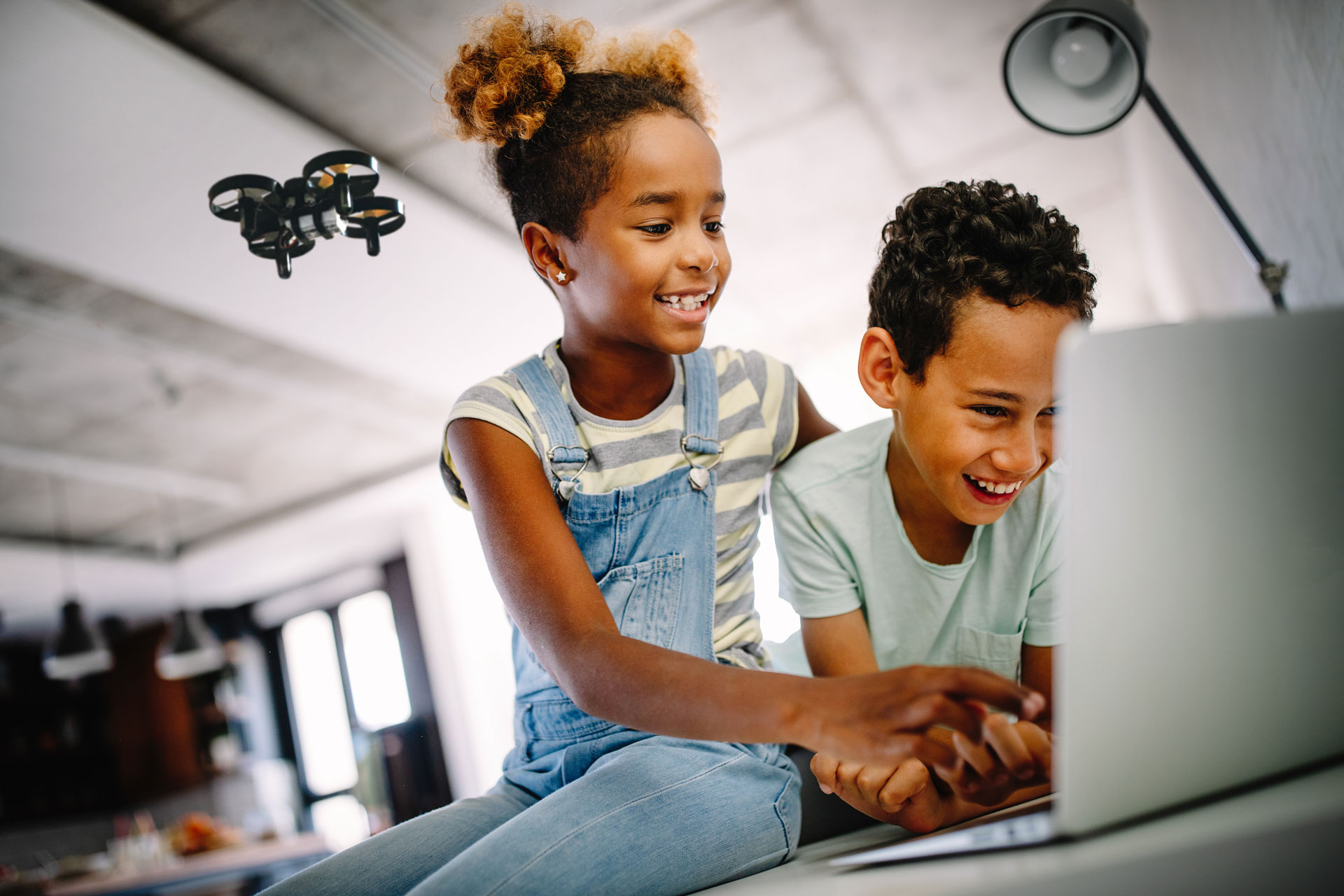 Boy and girl using CoDrone Mini